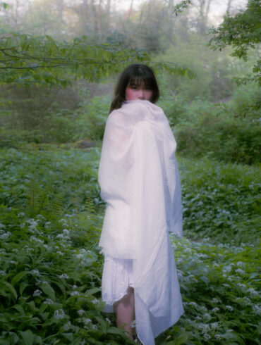 amanda standing in the middle of the forest in white fabric